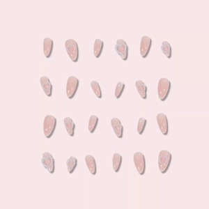 Almond press-on nails with nude pink gradient, pearl heart accents and 24 pieces set