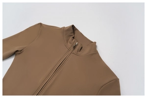 Detail shot of the stand-up collar with metal zipper on a brown yoga bodysuit