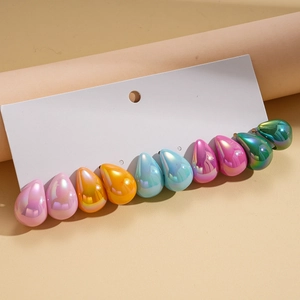 Macro view of ten teardrop acrylic earrings with pearlescent finish on white display card
