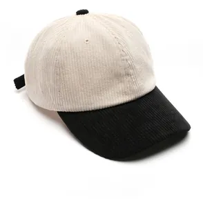 Close-up of corduroy baseball cap texture with black brim and cream crown details