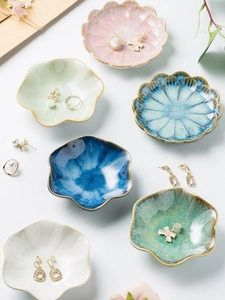 Detail of petal-shaped ceramic jewelry trays with smooth glazed finish in pastel colors