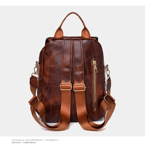 Detailaufnahme des braunen Retro-Rucksacks mit edler Litschinarbung und Goldreißverschluss