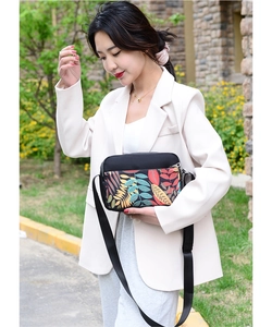 Close-up of lightweight printed oxford cloth crossbody bag with multi-layer zippers