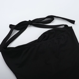 Detail of black halter neck ties and stitching on high-stretch vacation maxi dress