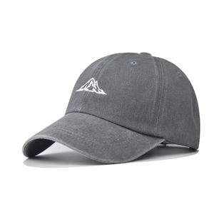 Detailed embroidery of white mountain peaks on a vintage washed grey cotton baseball cap