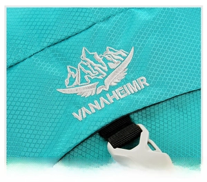 Close-up of VANAHEIMR brand embroidery on waterproof blue ripstop outdoor backpack fabric