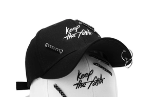 Detail of cotton baseball cap with iron rings and Keep the faith embroidery accents
