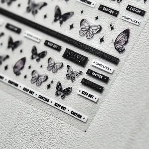5D dark butterfly nail stickers with gothic caution labels in black and white finish