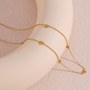 Gold plated stainless steel necklace with multiple engraved heart pendants on a chain