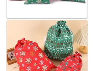 Detail of red and green burlap Christmas drawstring gift bags with reindeer prints