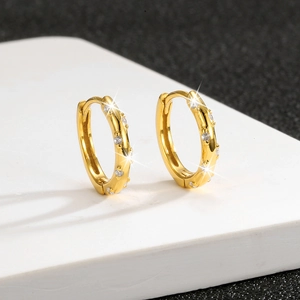 Close-up of gold S925 sterling silver hoop earrings with shimmering pavé set cubic zirconia