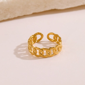 Adjustable gold plated stainless steel chain link ring for women on a warm neutral background