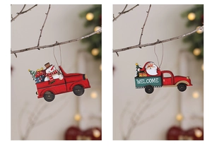 Close-up of wooden Christmas truck ornaments hanging on branches with warm bokeh