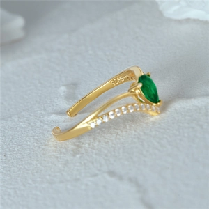 Close-up of S925 silver stamp on gold ring with green drop-shaped stone inlay