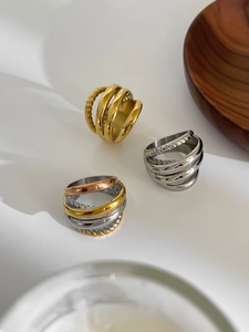 Detail of multi-layer hollow 18K gold plated rings with twisted texture and mixed metal finish