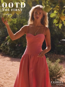 Detail of peach pink cotton dress with sweetheart neckline and smocked waist design