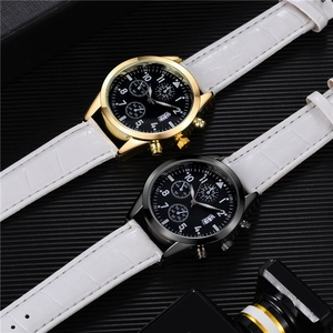 Macro detail of multi-functional quartz watches with white leather straps and three-eye dials
