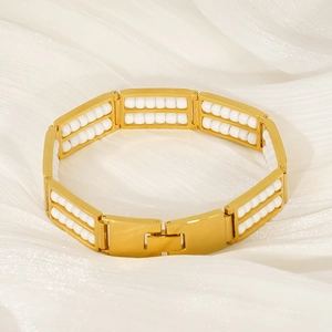 Detail of gold titanium steel bracelet featuring double row natural white stone beads