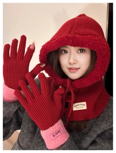 Detail of red knit balaclava hoodie and matching fingerless gloves with pink wrist trim