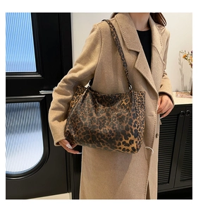 Fashionable leopard print tote bag styled with a beige coat for a trendy autumn look