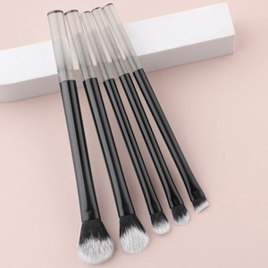 Detail of 5 mini makeup brushes with crystal handles and black-white gradient bristles