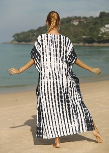 Full back view of a breezy long black and white tie-dye kaftan beach cover-up with side slits