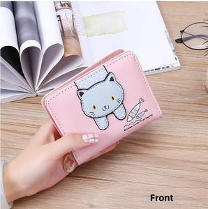 Close-up of pink cat print wallet with heart charm and decorative ribbon detail