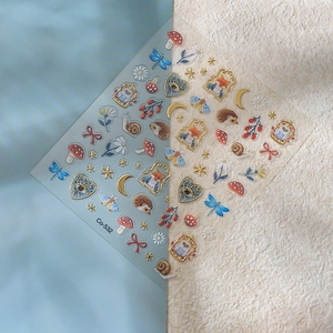 Detail of 5D embossed hedgehog and fox nail stickers with metallic gold outlines
