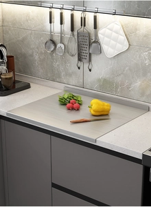 Macro detail of stainless steel cutting board with L-shaped fold on marble countertop