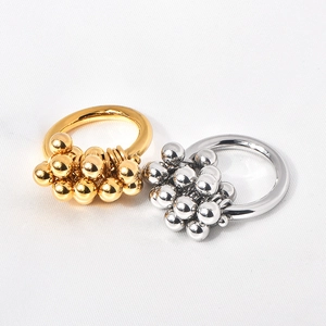Macro shot of 18k gold and silver clusters of polished metallic beads on rings
