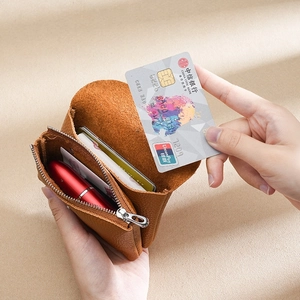 Brown litchi grain genuine leather coin purse showing interior card and lipstick capacity