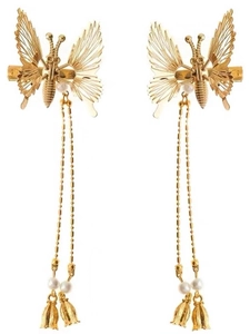 Detail of golden butterfly hair clips with long beaded tassels and pearl accents
