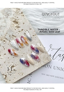 Detail view of artistic press-on nails with silver texture and white flower patterns