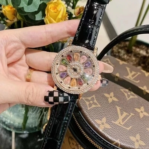Detail of luxury rotating watch with diamond bezel and black leather strap