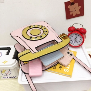 Interior view of vintage pink telephone bag showing storage capacity for daily essentials