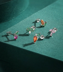 Macro shot of S925 sterling silver fruit earrings with colorful zircon inlays detail