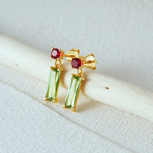 Detail of S925 silver drop earrings with red round crystal and green rectangle gemstone