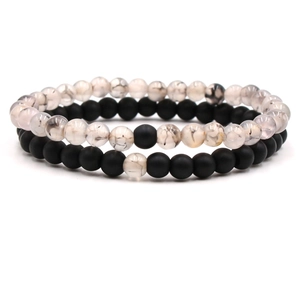 Close-up of 8mm matte black agate and white dragon vein stone distance bracelets