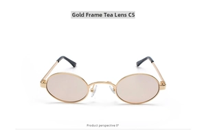 Macro detail of oval vintage sunglasses with gold metal frame and tea tinted lenses