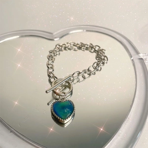 Detail of color-changing heart pendant on a silver-tone chain with toggle clasp