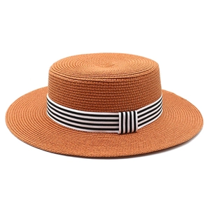 Close-up showing the tight woven texture and striped ribbon on this flat top straw hat