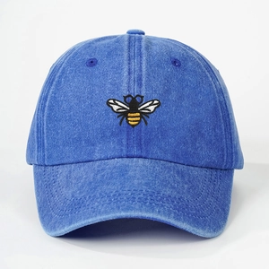 Vintage washed blue denim baseball cap featuring detailed bee embroidery on the front