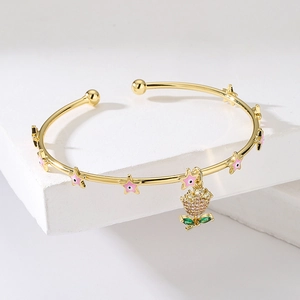 18K gold plated bangle with pink enamel stars and a sparkling floral zircon pendant
