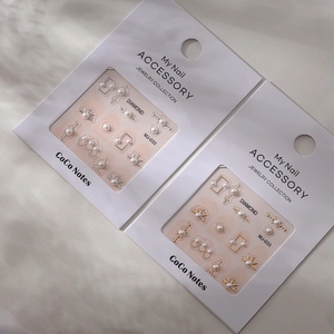 Detail of DIY pearl nail art charms in gold and silver frames on CoCo Notes packaging