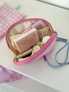 Pink puppy makeup bag with zipper closure and spacious interior compartments for cosmetics