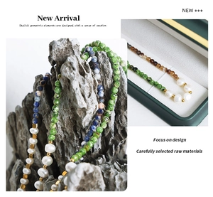 Macro detail of natural freshwater pearls and colorful gemstones with gold spacers