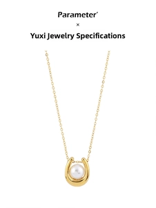 Close-up of gold U-shaped pendant with a single white pearl on a delicate fine chain