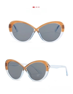 Dettaglio occhiali da sole cat eye con montatura bicolore arancione e blu e lenti grigie