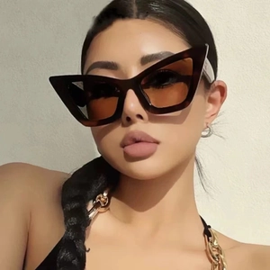 Oversized triangular cat-eye sunglasses in tortoiseshell frame with brown lenses