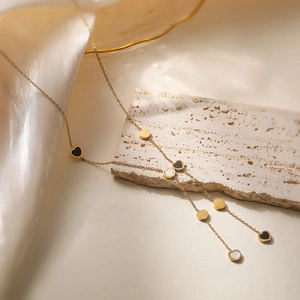 Elegant 18K gold-plated layered necklace with black, white and gold heart pendants